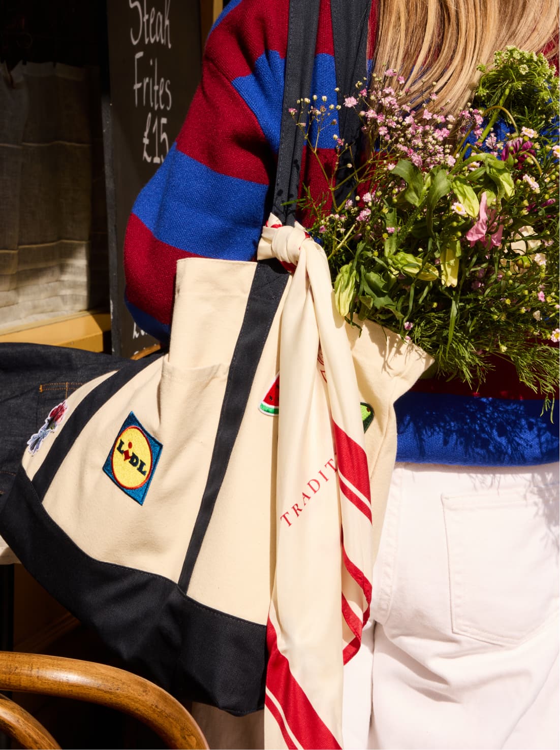 Lidl tote with flowers and a scarf beside a striped jumper