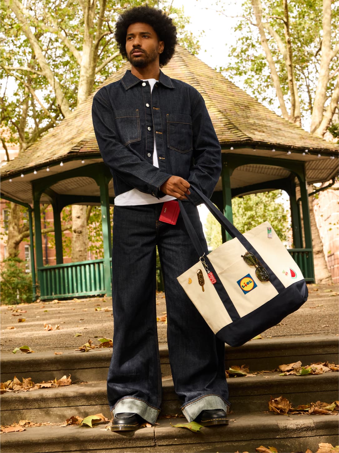 A shopper carrying a personalised Lidl tote in a park